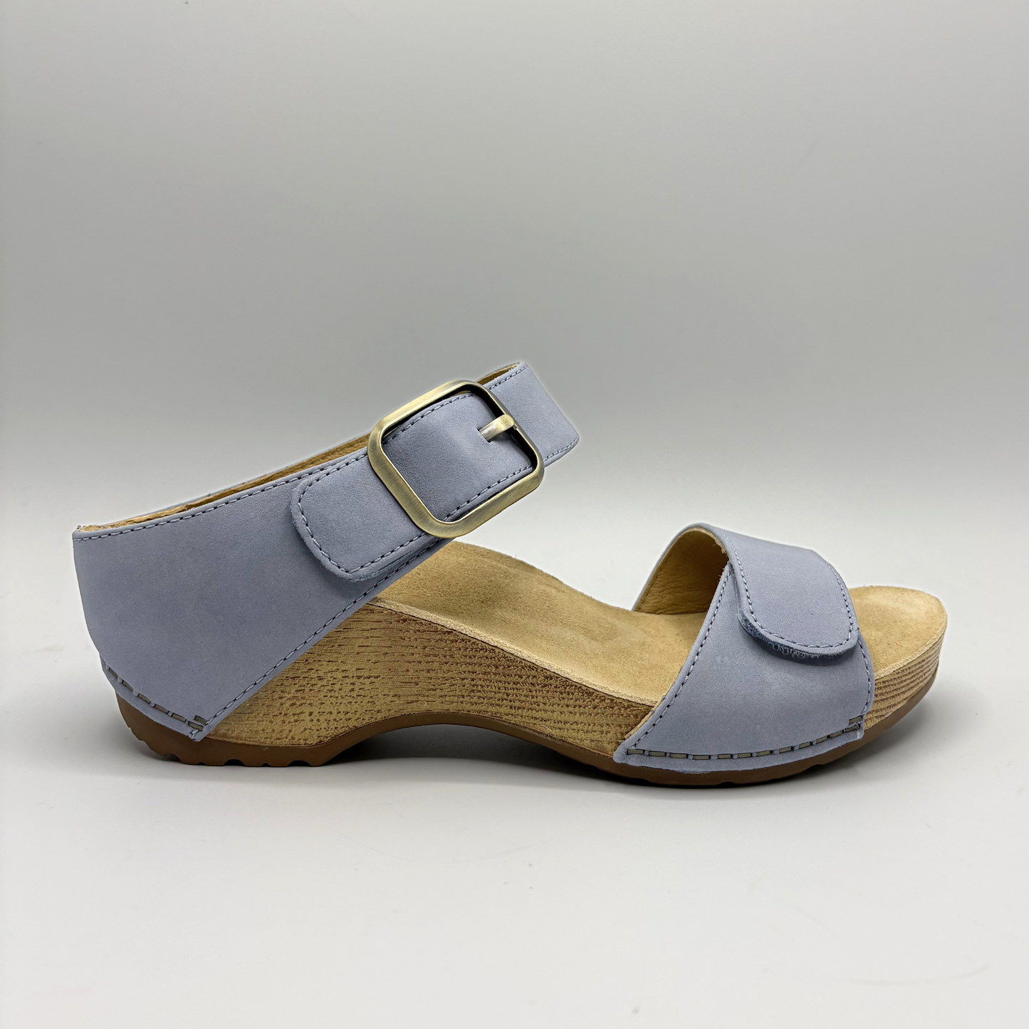 Blue sandal with wooden sole on a gray background