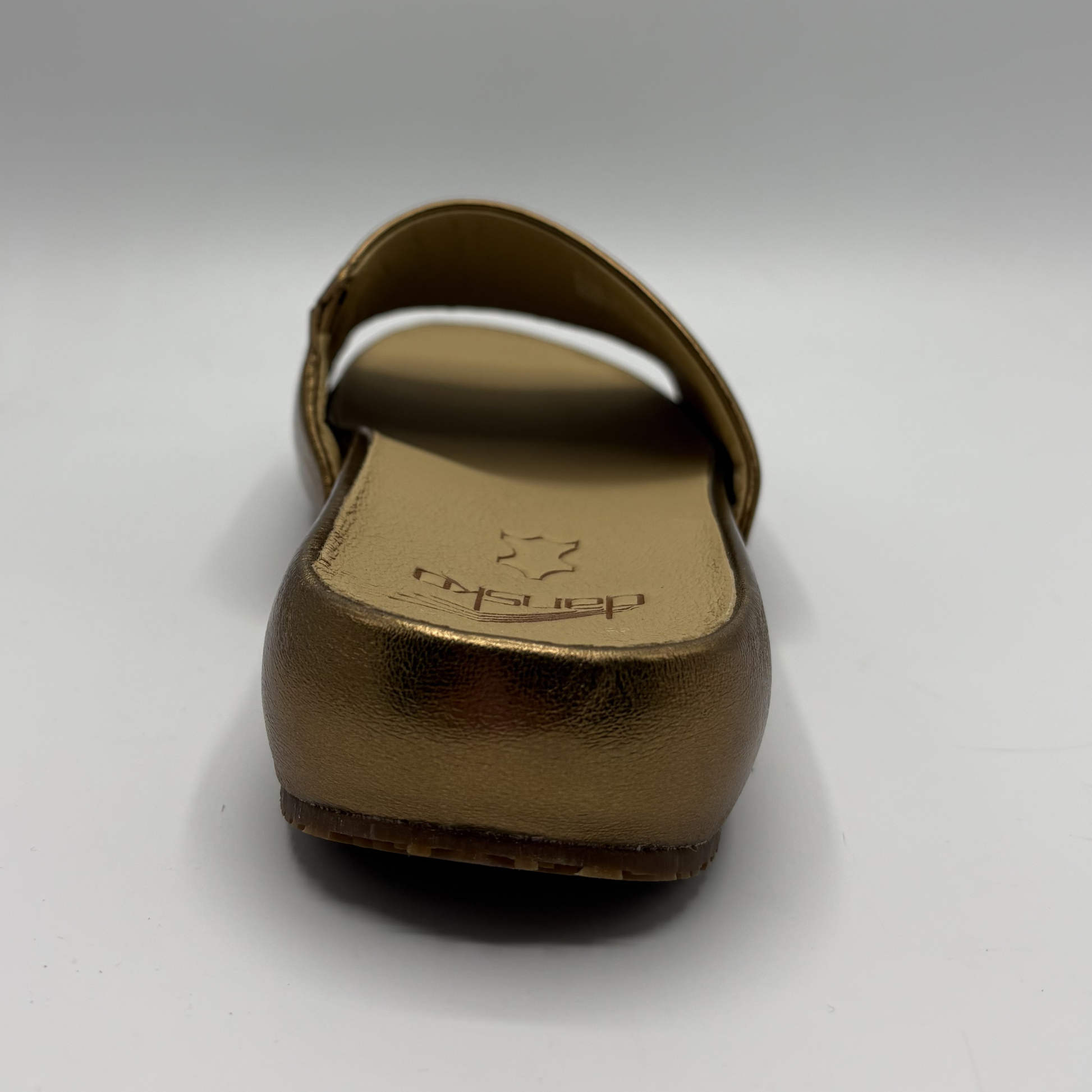 Bronze-colored sandal on a white background