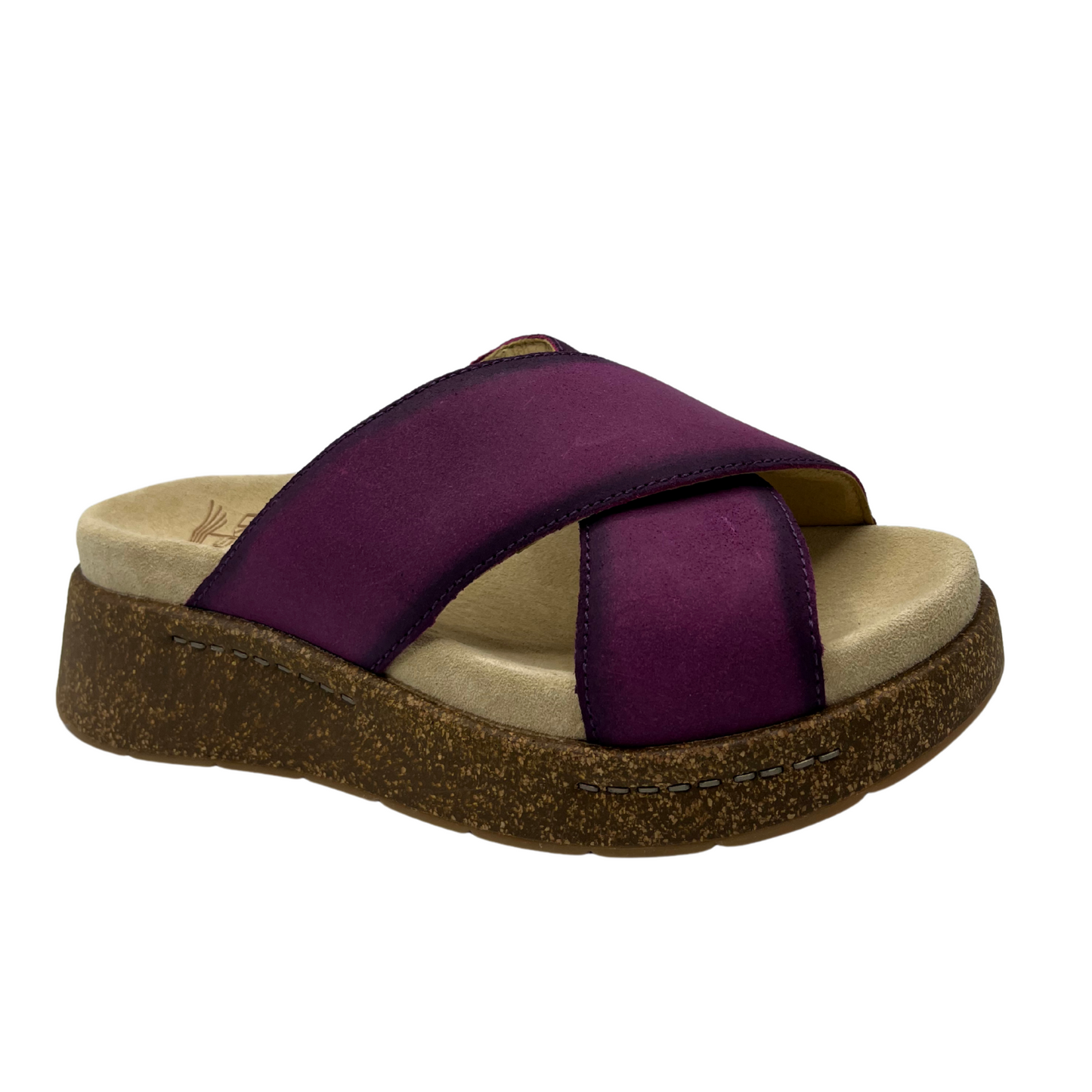 Angled view of plum suede slip on sandal with thick crossed straps, thick cork outsole and suede wrapped footbed.