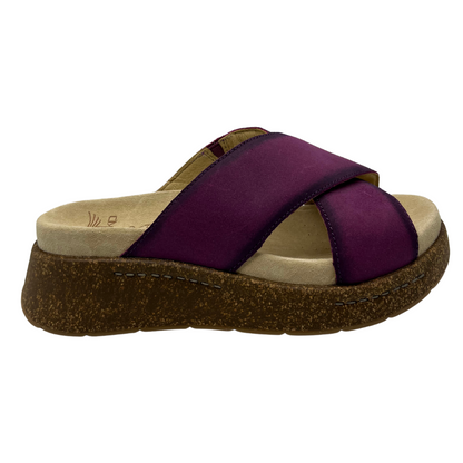 Right facing view of plum suede slip on sandal with thick crossed straps, thick cork outsole and suede wrapped footbed.