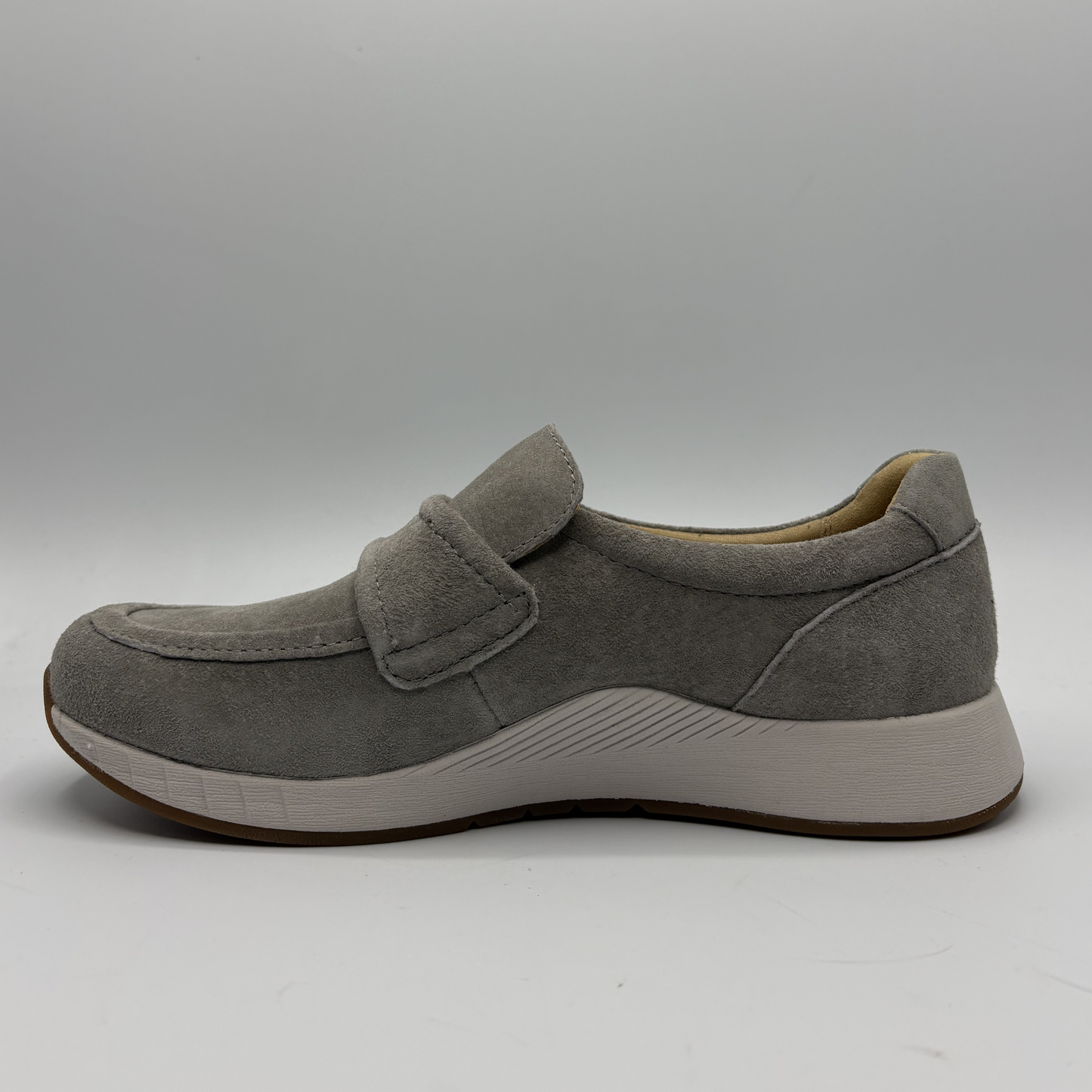 Gray shoe with a strap on a gray background