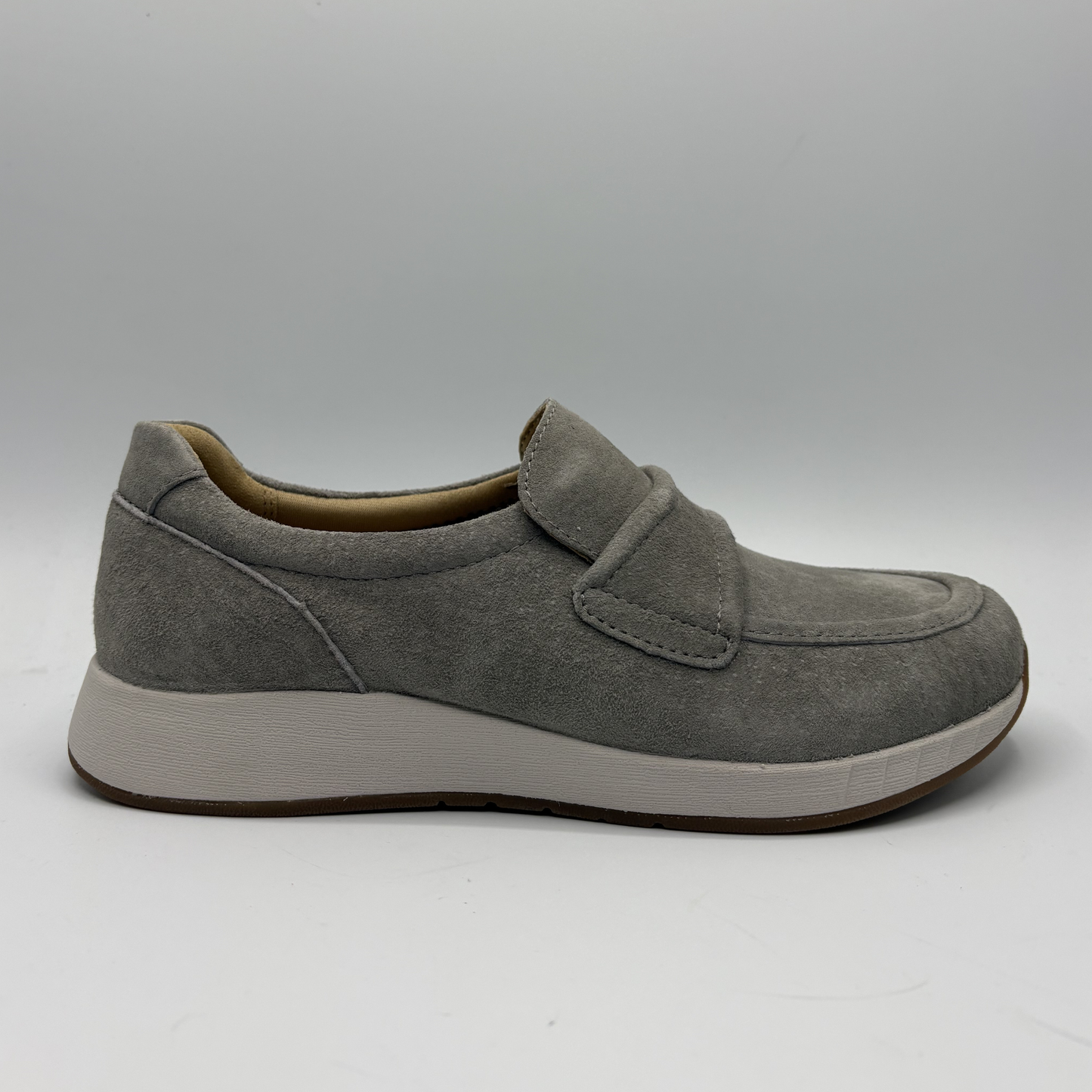 Gray shoe with a velcro closure on a gray background
