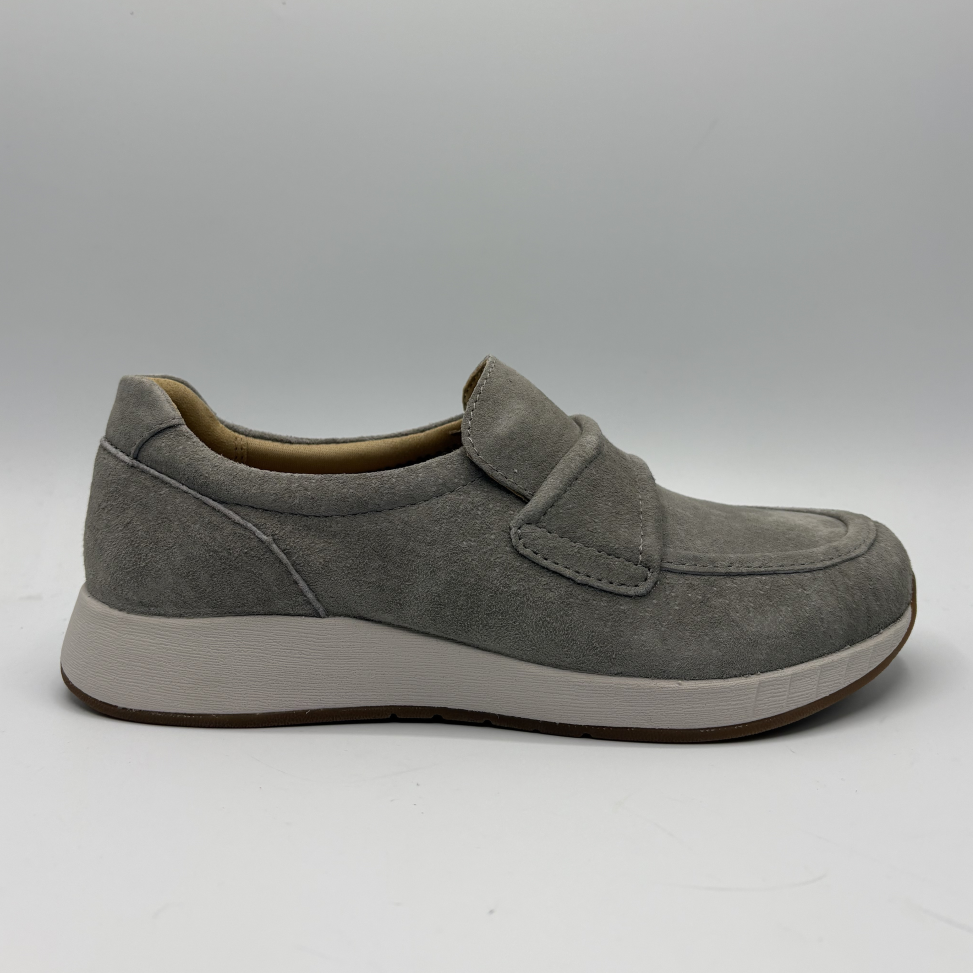 Gray shoe with a velcro closure on a gray background