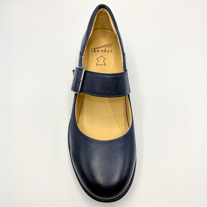 Navy blue shoe with a buckle on a light gray background