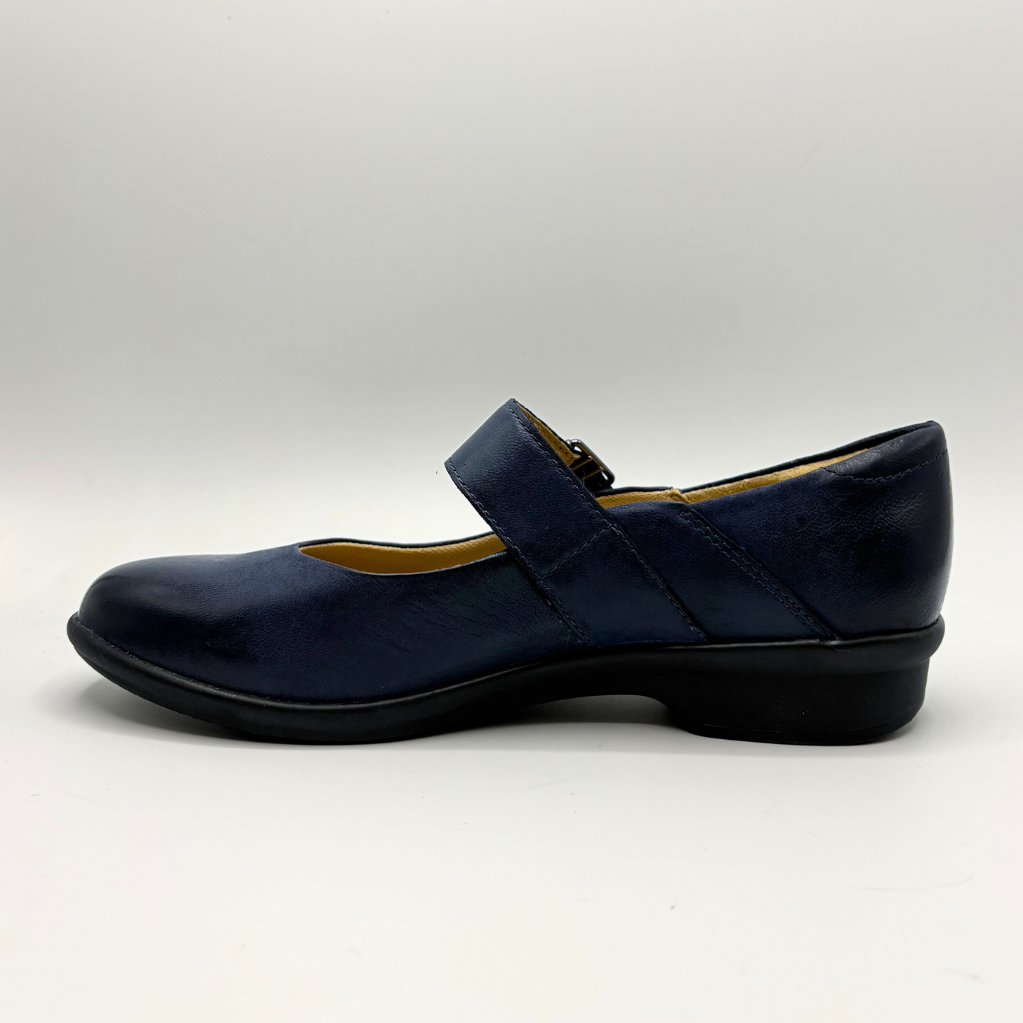 Navy blue shoe with a strap on a white background