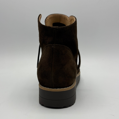 A dark brown suede ankle boot shown from the back, featuring a chunky black platform sole with a tan midsole layer.