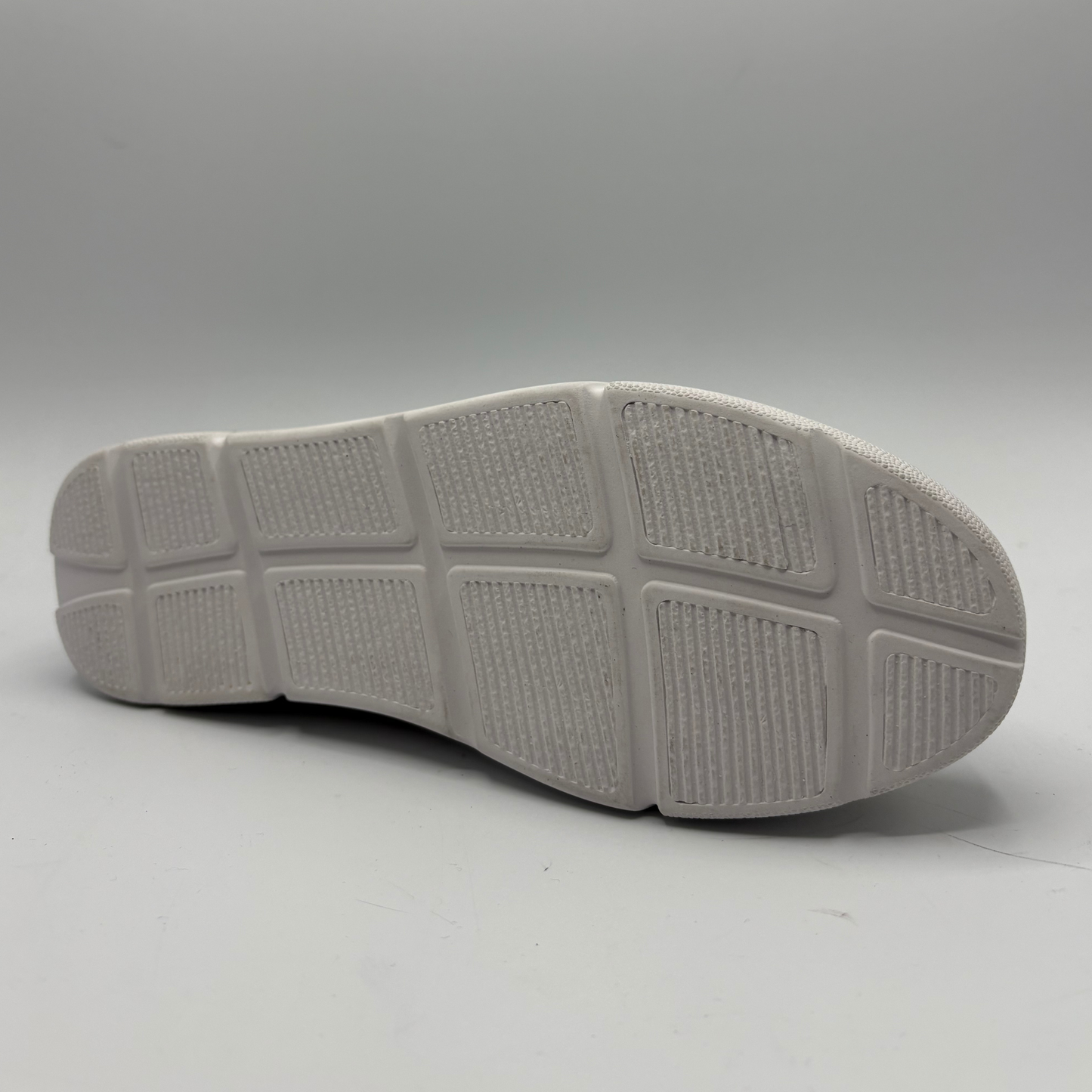 Gray shoe sole on a light gray background