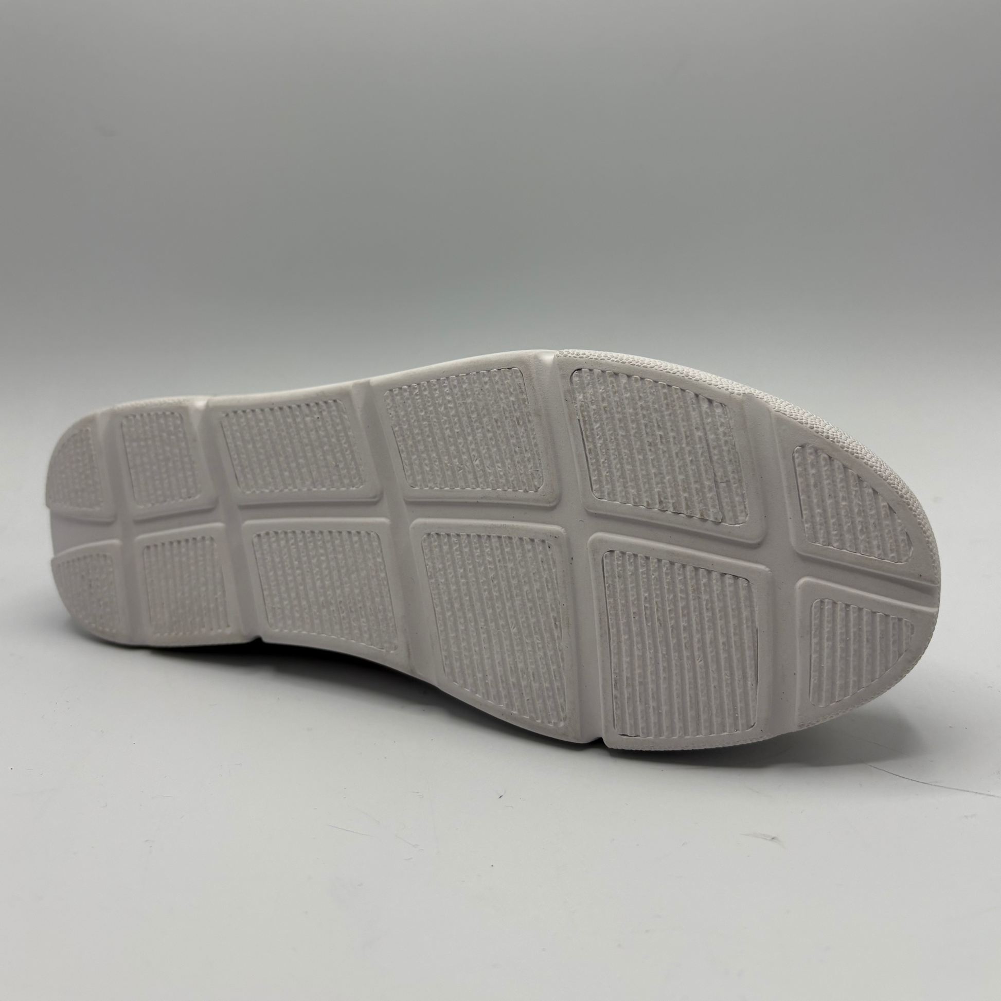 Gray shoe sole on a light gray background