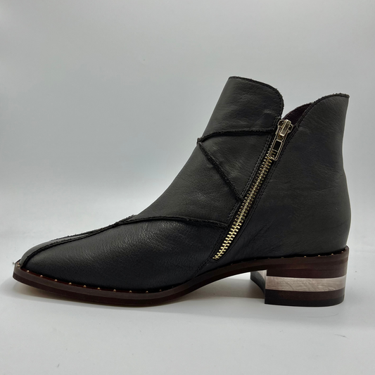 Left facing view of a leather ankle boot with a gold zipper