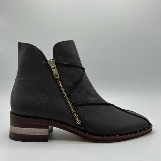 Right facing view of a leather ankle boot with a gold zipper