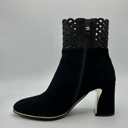 Left facing view of a black high heeled boot with shimmer detail