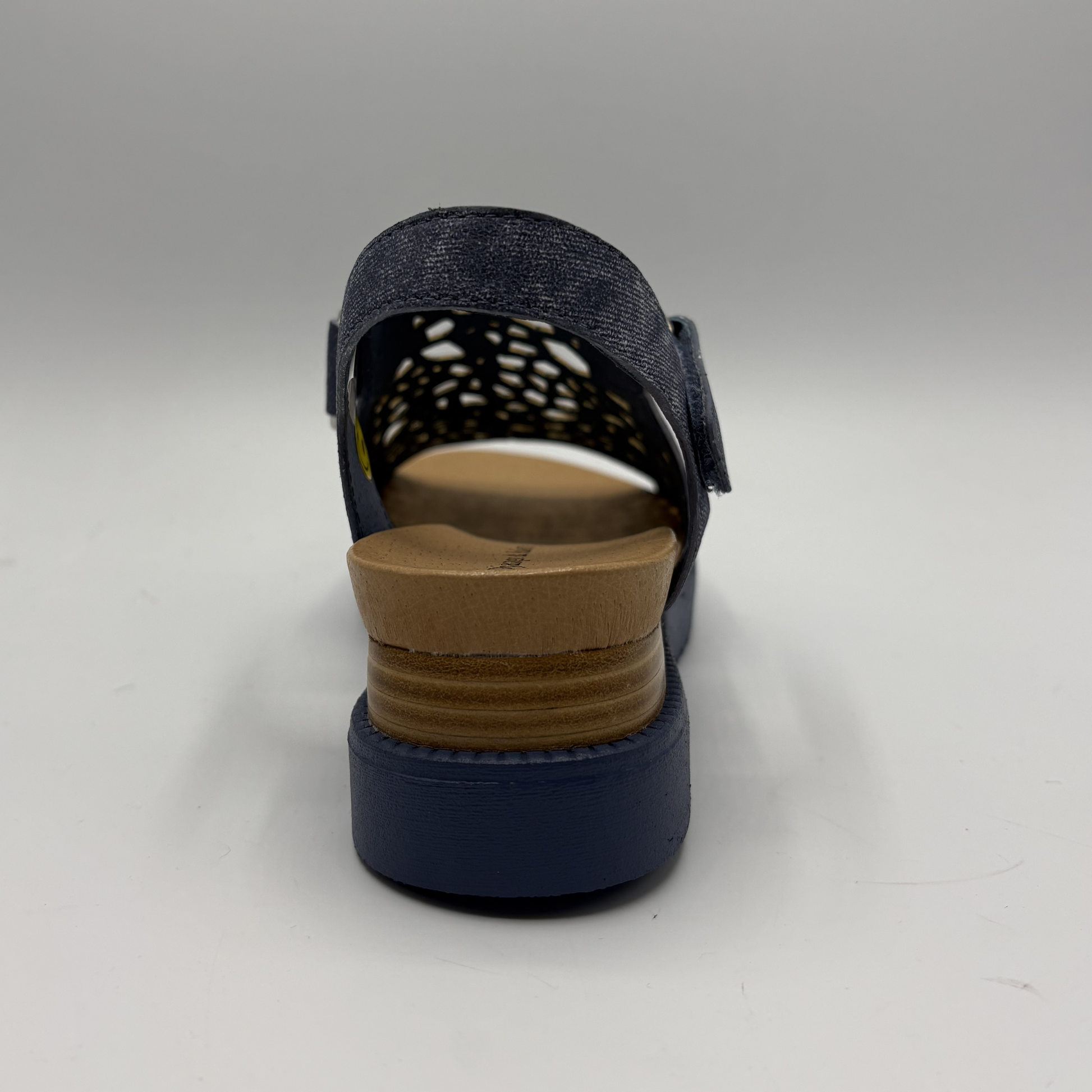 Navy sandal with a brown sole on a white background