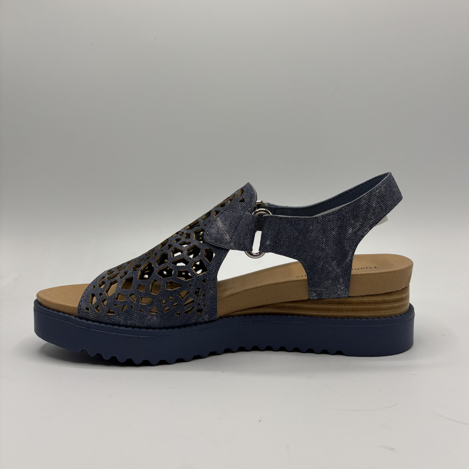 Navy sandal with cut-out design on a gray background