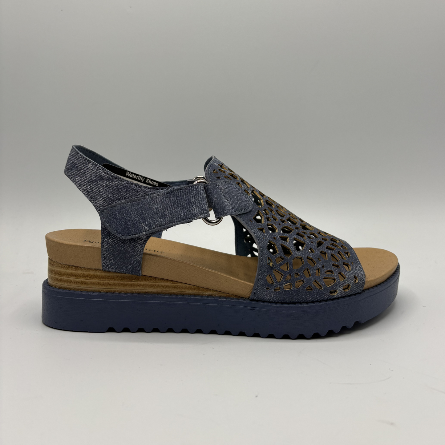 Blue sandal with brown sole on a gray background