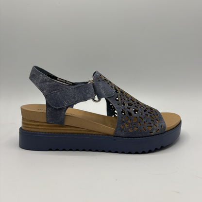 Blue sandal with brown sole on a gray background