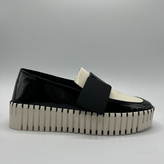 Black and white platform shoe on a gray background
