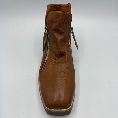 A single brown leather ankle boot with side zippers, shown from a front-facing perspective on a plain white background.