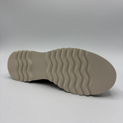 Close-up of a beige shoe sole on a light gray background