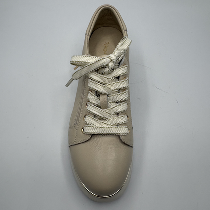Beige sneaker with white laces on a gray background