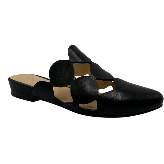 45 degree angled view of black leather slip on mule with circular cutouts and 1 inch heel