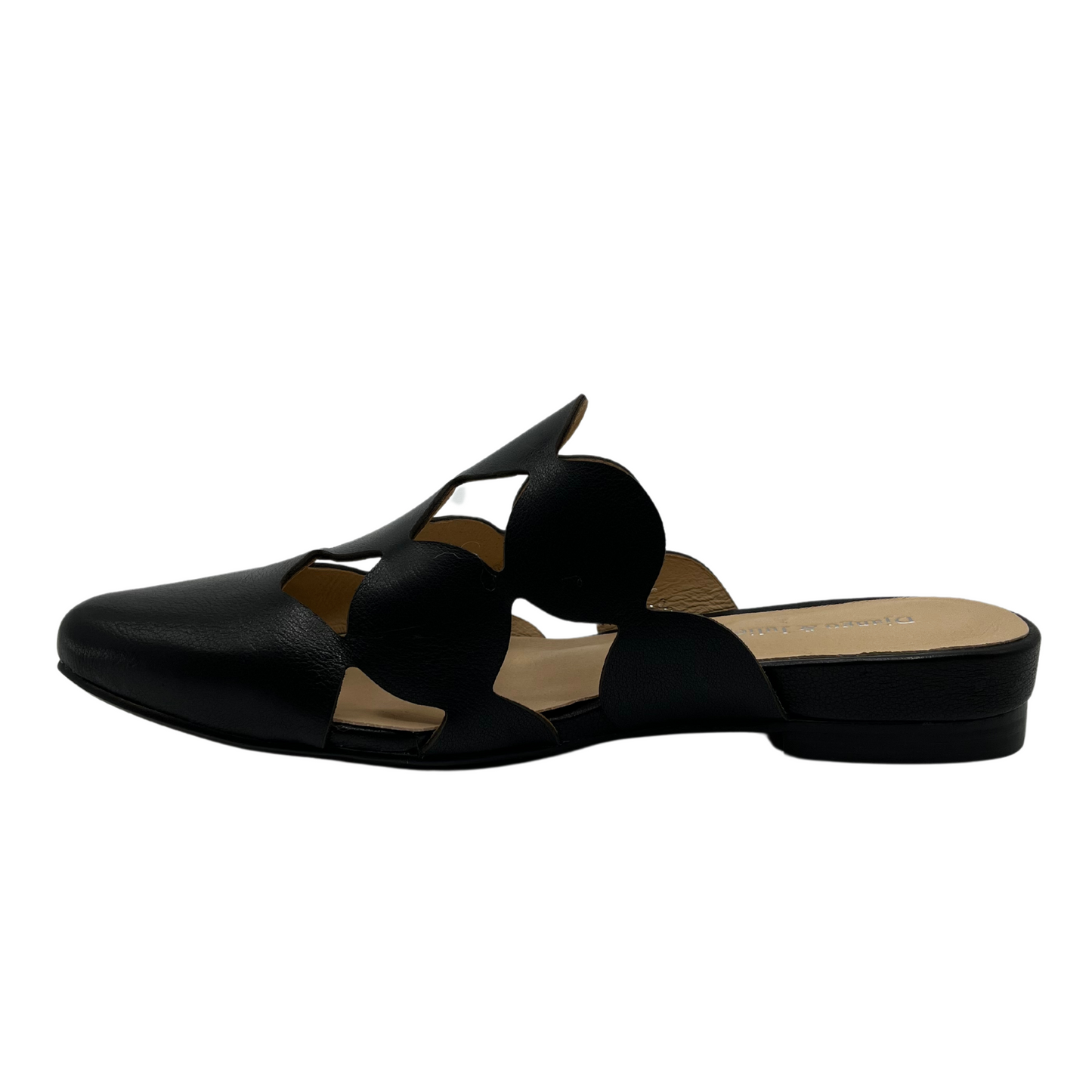 Left facing view of black leather slip on mule with circular cutouts and 1 inch heel