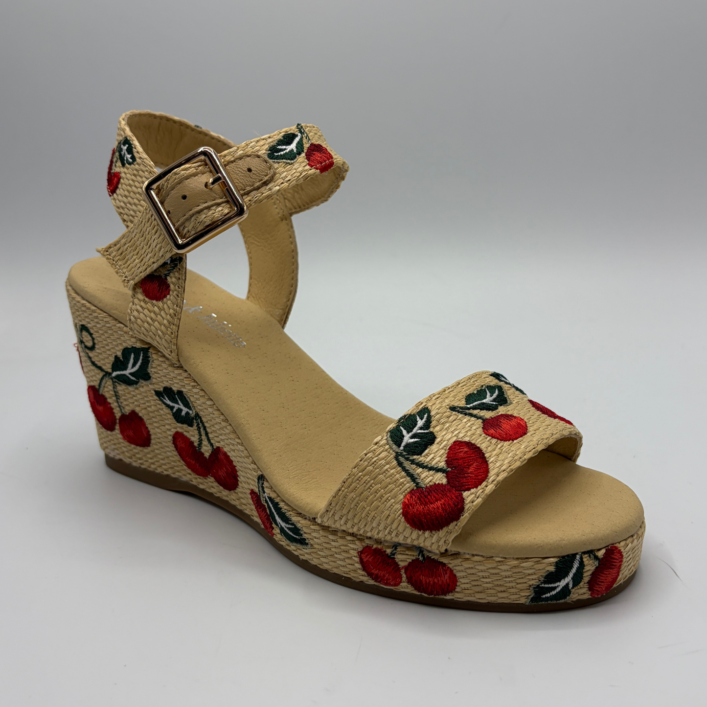 Beige wedge sandal with cherry design on a gray background