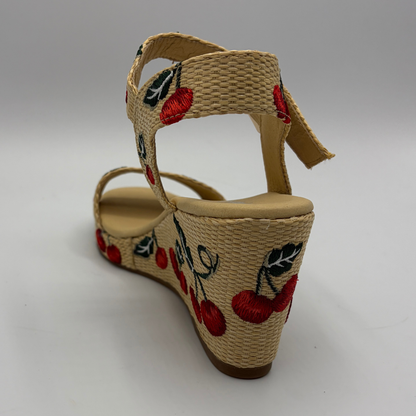 Woven sandal with cherry design on a gray background