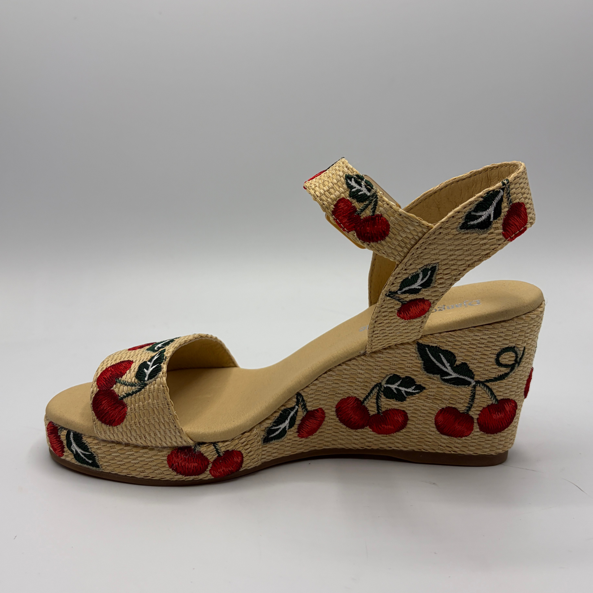 Wedge sandal with cherry design on a gray background