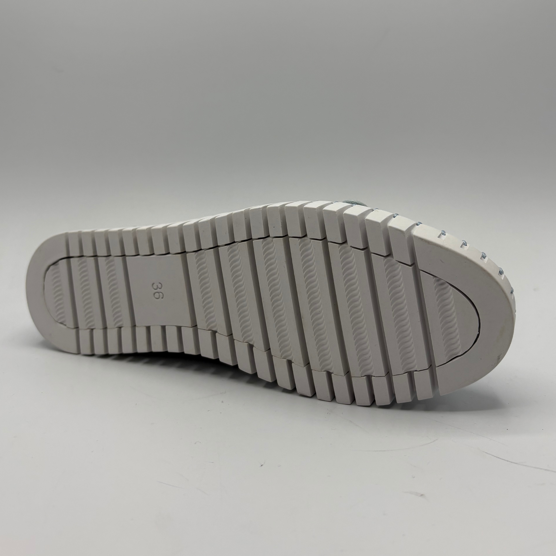 White shoe sole on a light gray background