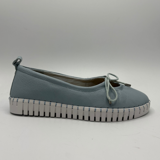 Blue shoe with a white sole on a gray background