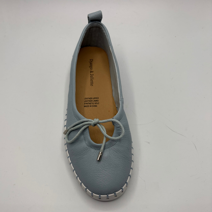 Blue leather shoe with a white sole on a light gray background