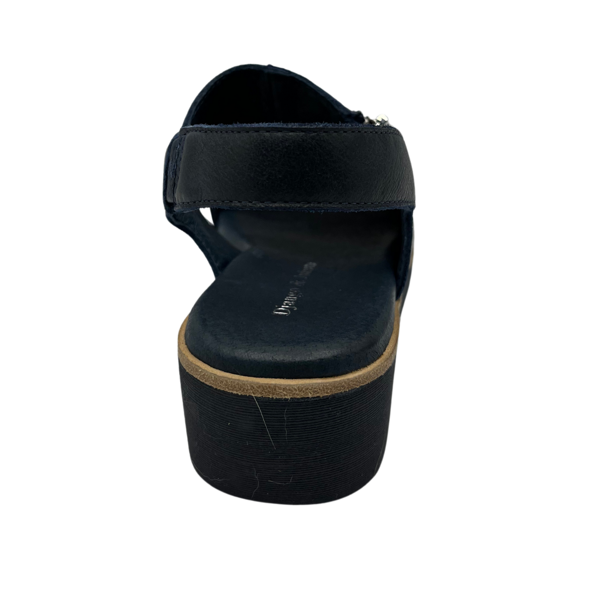 Back view of navy leather sandal with a silver size zipper, square toe, low wedge heel and sling back strap.