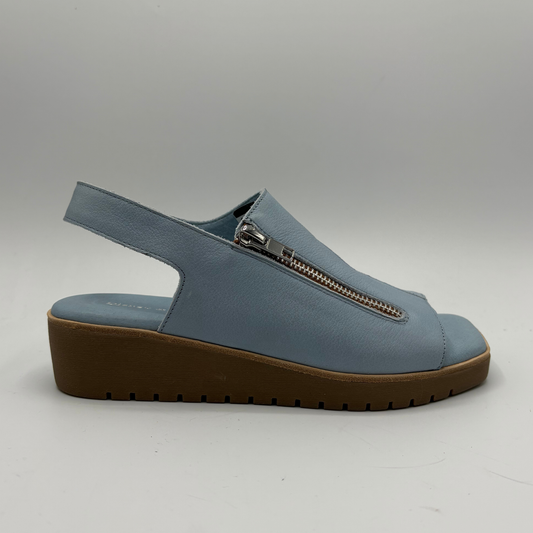 Blue sandal with a brown sole on a gray background