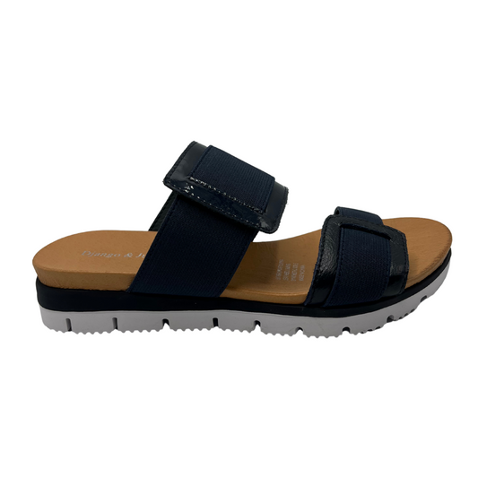 Right facing view of navy slip on sandal with a lightweight, flexible outsole.
