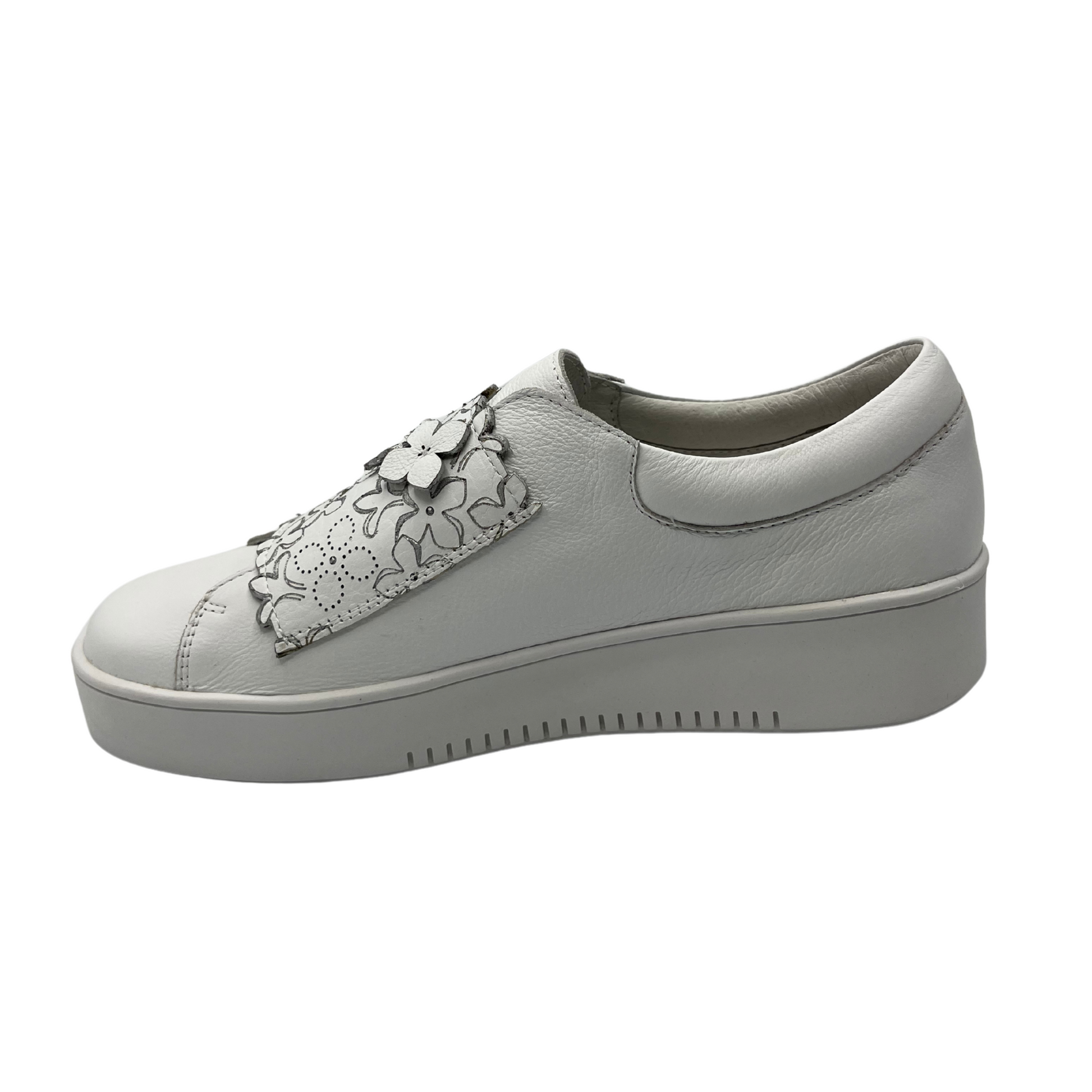 Left facing view of white leather sneaker with a 4.5cm platform sole and floral details on the large velcro strap.