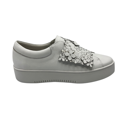 Right facing view of white leather sneaker with a 4.5cm platform sole and floral details on the large velcro strap.