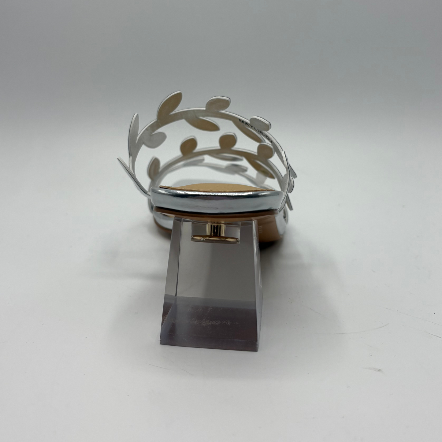 Silver shoe with decorative element on a white background