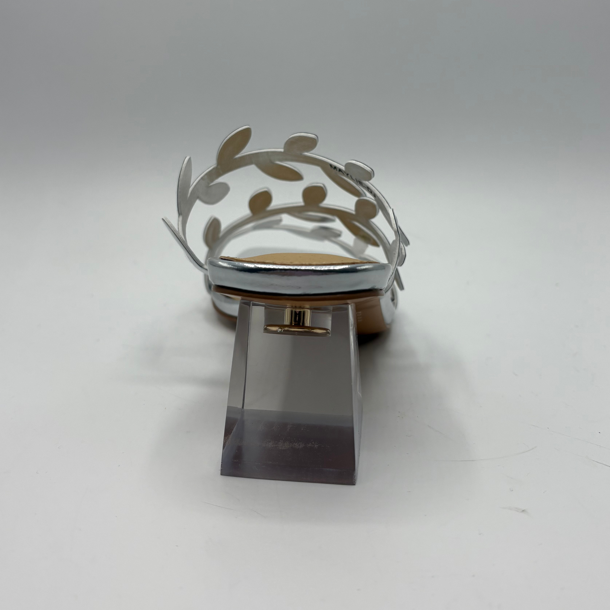 Silver shoe with decorative element on a white background