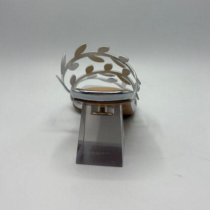 Silver shoe with decorative element on a white background