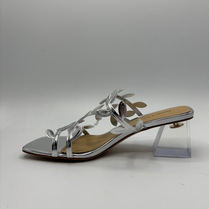 Silver sandal with a clear heel on a gray background