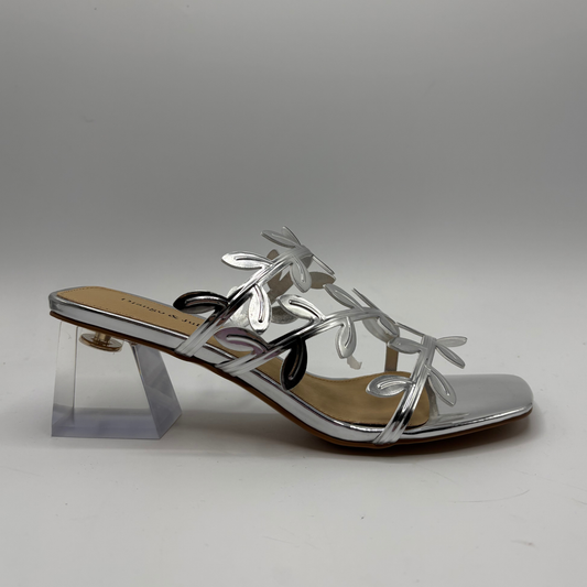 Silver sandal with clear heel on a gray background