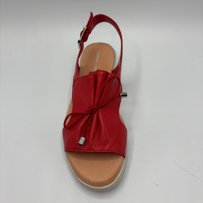 Red sandal with a bow on a white background