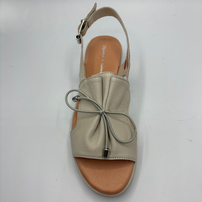 Beige sandal with bow detail on a white background