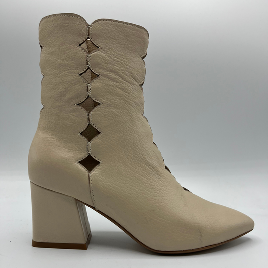 Beige ankle boot with cut-out design on a white background