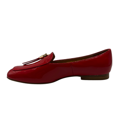 Left facing view of a red patent leather loafer with a 0.8" heel and a gold and red tassel accent on the toe box.