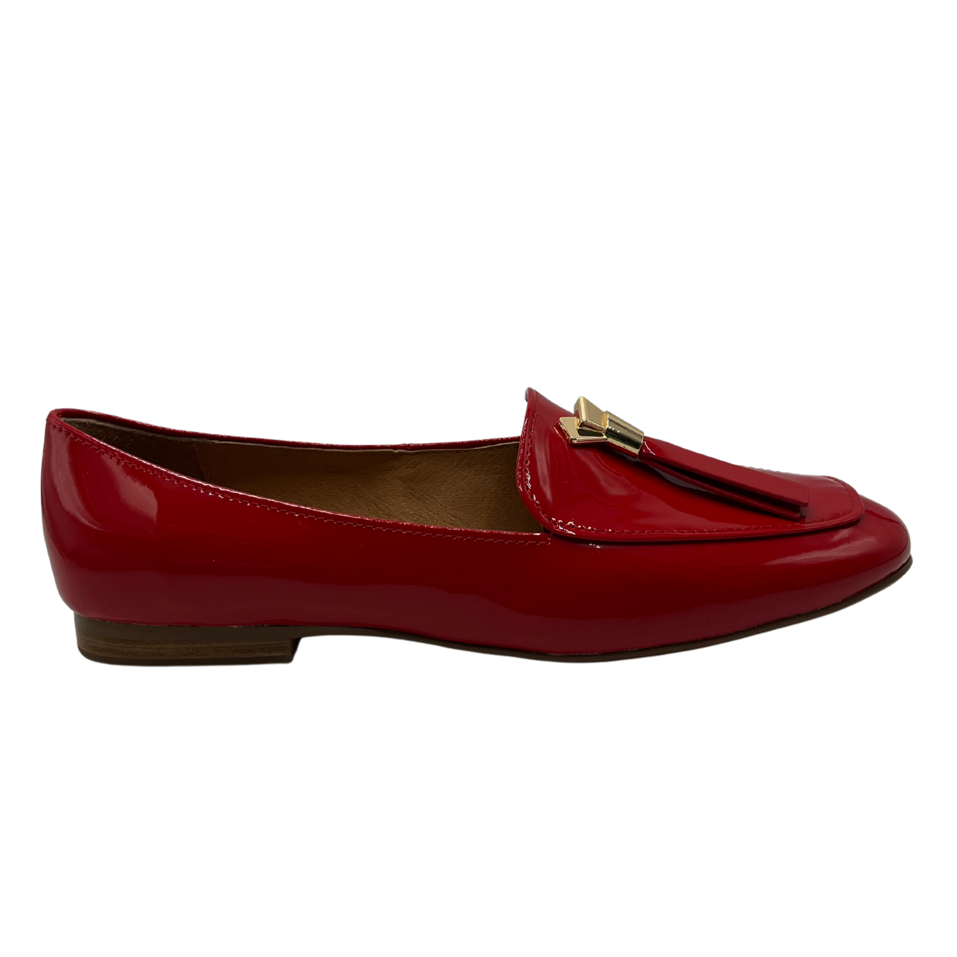 Right facing view of a red patent leather loafer with a 0.8" heel and a gold and red tassel accent on the toe box.