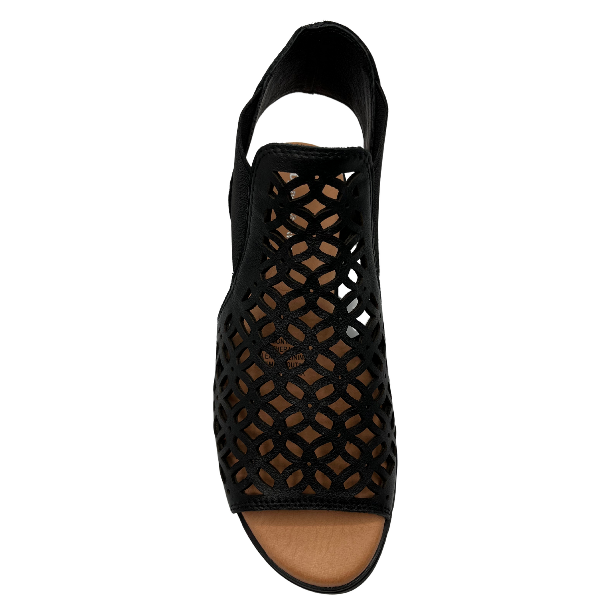 Top view of leather die cut wedge sandal in black. Low wedge heel, elasticized sides and open toe 