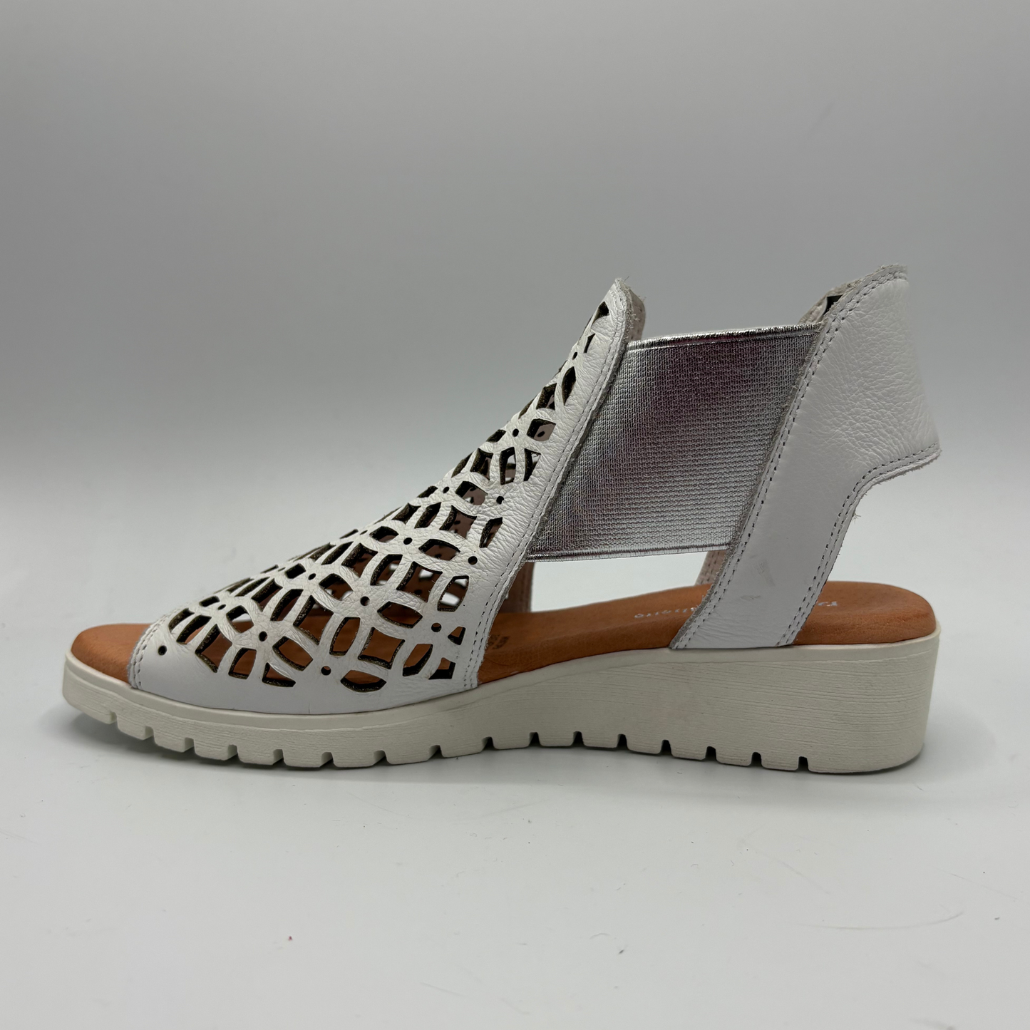Gray sandal with cut-out design on a gray background