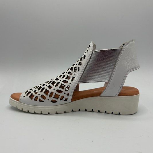 Gray sandal with cut-out design on a gray background