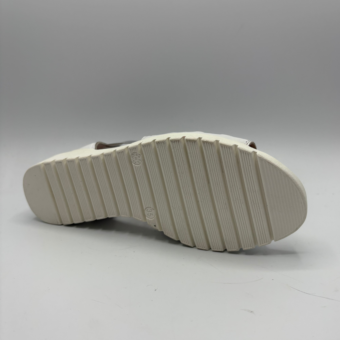 White sole of a shoe on a gray background